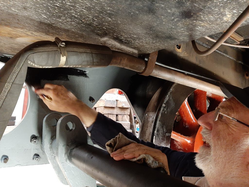 Phil Bell paints the inside of FR 20's tender steps