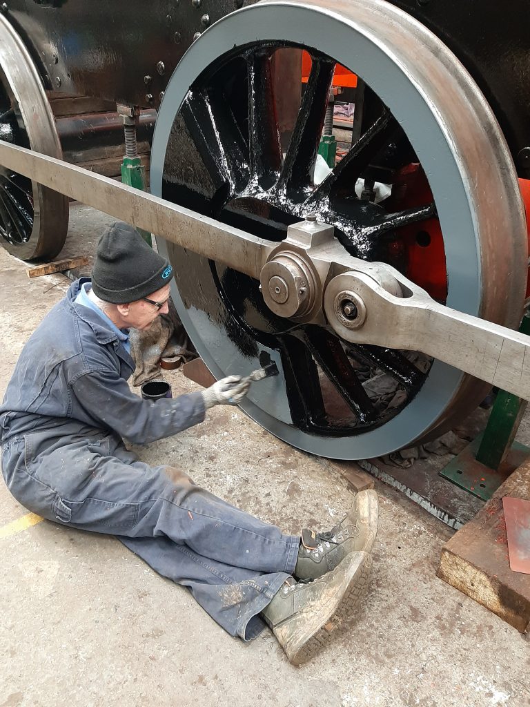 Jon Dixon painting gloss black paint on to one of 5643's driving wheels